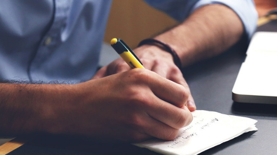 Picture of a person writing.