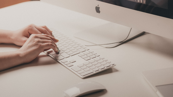 Person typing on keyboard.