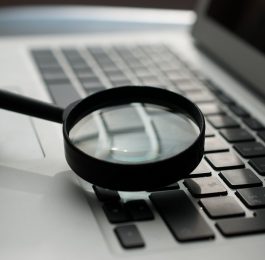 Magnifying glass on keyboard.