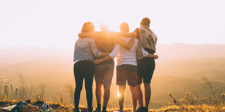Group of friends embracing each other.